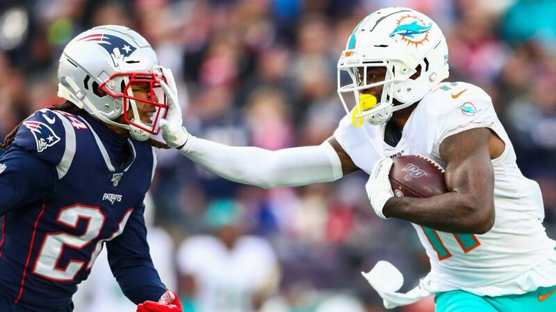 The Miami Dolphins’ DeVante Parker stiff arms Stephon Gilmore during his side’s win over the Patriots. Photograph: Adam Glanzman/Getty