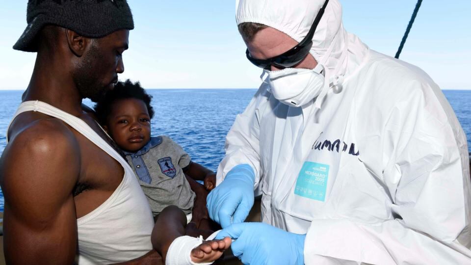 Rescuer: leading sick-berth attendant Alan Cummins treats a child aboard LÉ Eithne in the Mediterranean. Photograph: David Jones/Irish Defence Forces