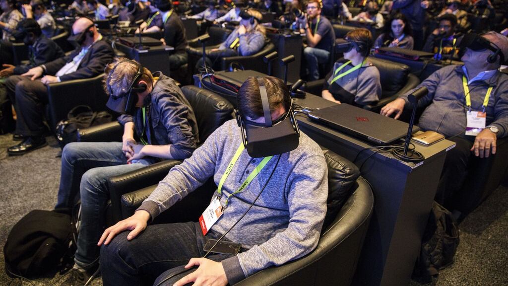 CES conference attendees try out  Oculus VR headsets: Facebook’s acquisition of Oculus gave it a head start in the  virtual reality market that is  forecast to exceed $84 billion in sales in 2020. Photograph: Bloomberg