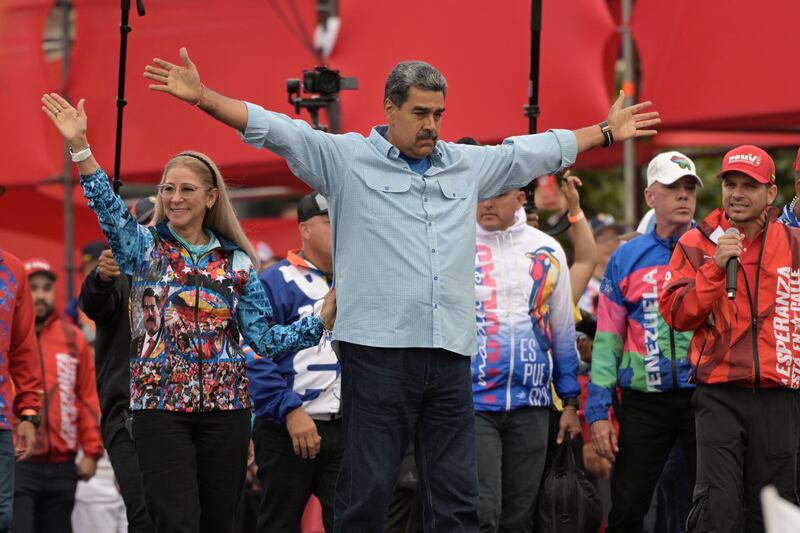 Nicolas Maduro (centre) greets supporters next to his wife, Cilia Flores, at his campaign closing rally in Caracas on Thursday. Photograph: Yuri Cortez/AFP via Getty Images