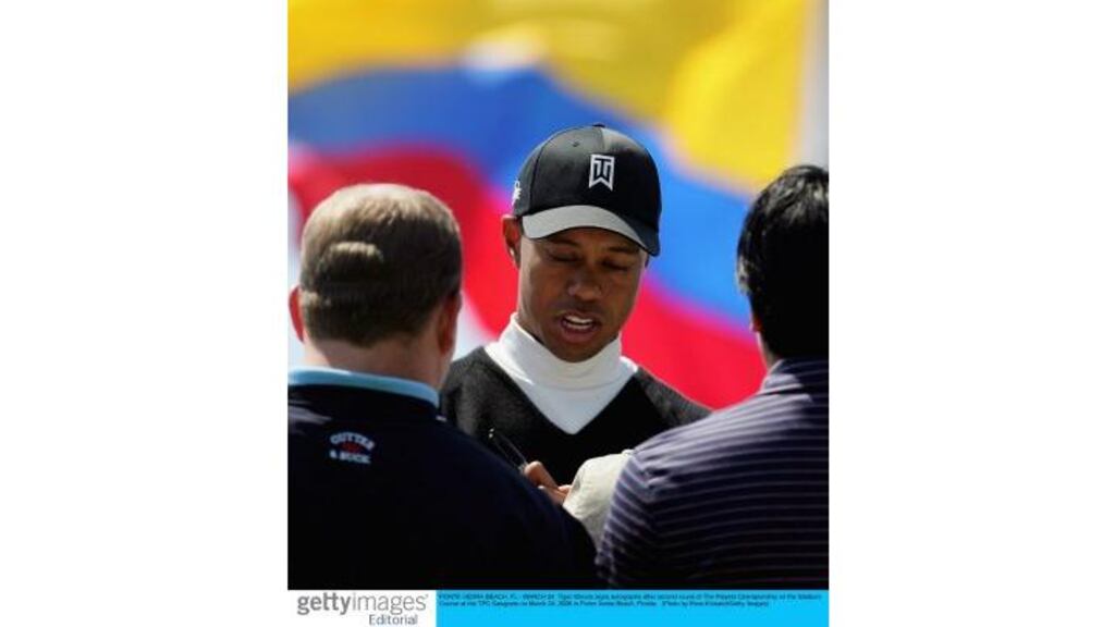 Tiger Woods signs autographs after yesterday's second round of the Players Championship at the TPC Sawgrass in Ponte Vedra Beach, Florida. The world number one fired a three-under-par 69 to get back into the tournament.