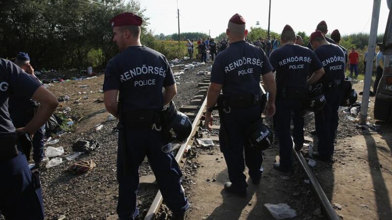 Hungarian police block the rail track at the Hungarian-Serbian border preventing migrants crossing before new laws come in to force at midnight on Monday. Photograph: Getty