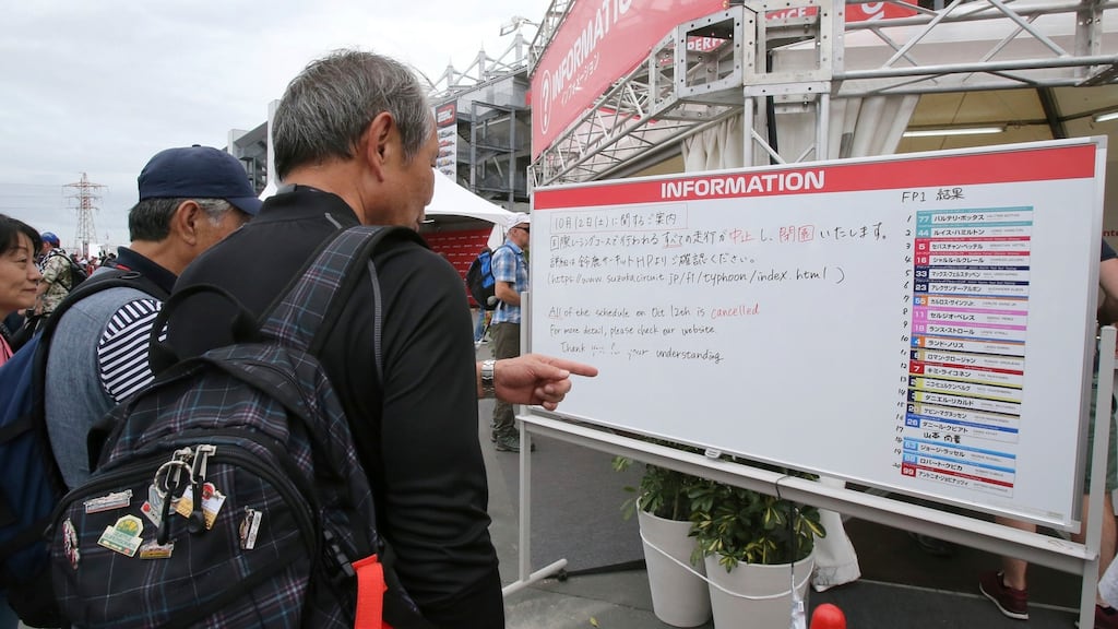 Visitors to the Suzuka circuit looking at an information board showing that Saturday’s qualifying session for the Japanese Grand Prix has been cancelled. Photograph: AP Photo/Toru Takahashi