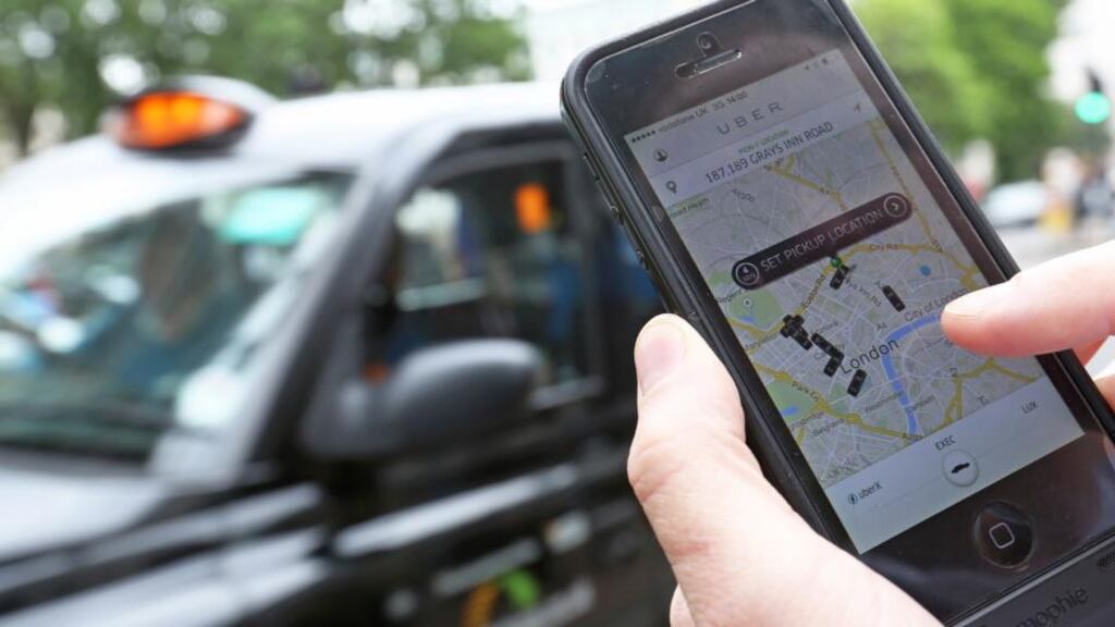 A user scans for an available vehicle using the Uber Technologies app on an Apple iPhone 5. Photograph: Chris Ratcliffe/Bloomberg