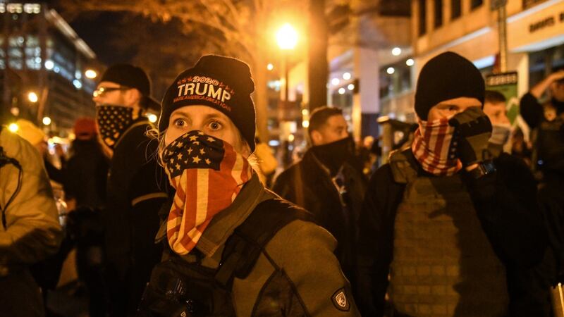 A woman with the Proud Boys wears an American flag bandana during a protest on December Saturday in Washington DC. Photograph: Stephanie Keith/Getty Images