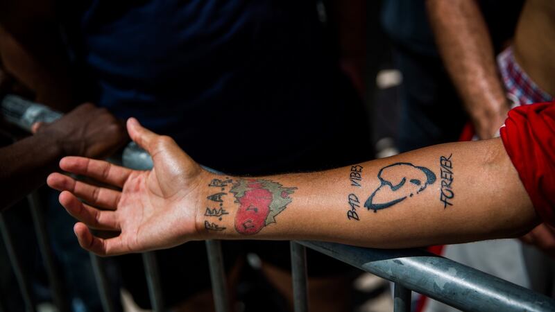 Tristen Smith, shows his tattoo ‘Bad Vibes Forever’ while he waits with other fans at a memorial and viewing for rapper XXXTentacion. Photograph: Scott McIntyre/The New York Times.