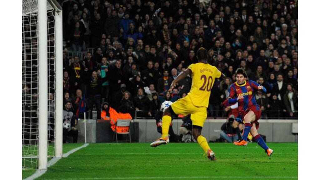 Lionel Messi fires Barcelona ahead after a sublime flick over the advancing Almunia. The world player of the year would add a second from the spot as Arsenal were beaten 3-1. Photograph: David Ramos/Getty Images