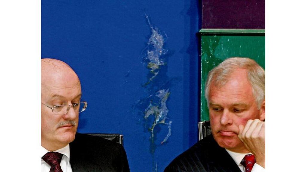 Stains behind AIB's John O'Donnell and Eugene Sheehy after eggs were thrown at the bank's egm last year. Such incidents, as well as name-calling and angry expletives on the airwaves and in the Dáil, indicate a coarsening of public discourse.