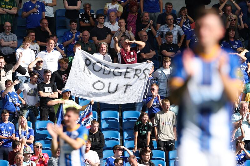 Leicester's supporters hold a banner up at full-time after the defeat to Brighton at the Amex Stadium. Photograph: Adrian Dennis/AFP via Getty Images)