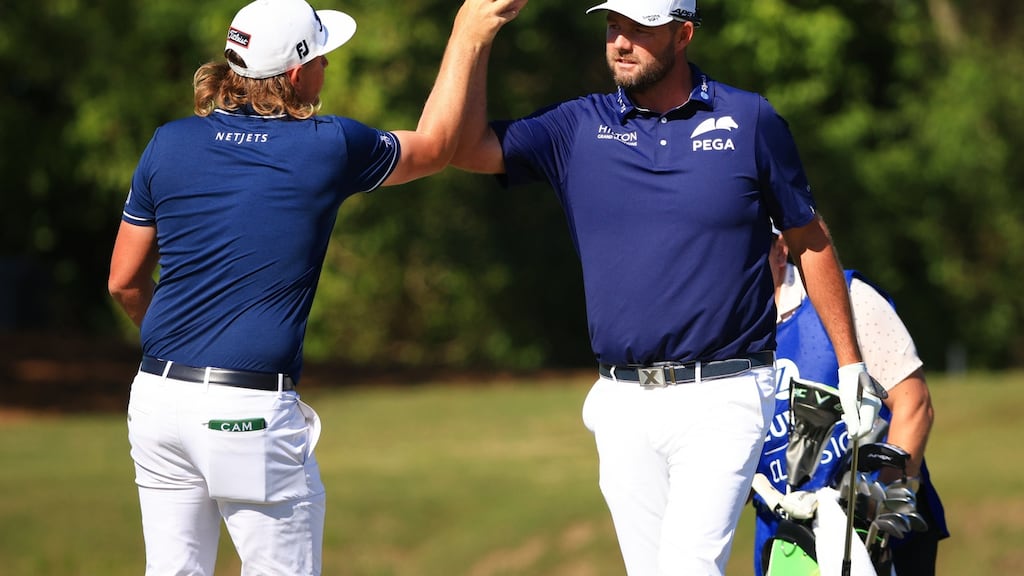 Cameron Smith high fives with his partner Marc Leishman during the final round of the Zurich Classic of New Orleans at TPC Louisiana. Photo: Mike Ehrmann/Getty Images