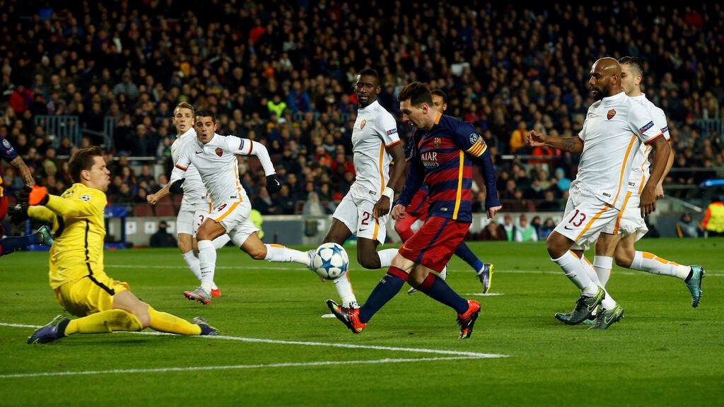 Barcelona’s Lionel Messi chips AS Roma goalkeeper Wojciech Szczesny to score his side’s second goal in the Champions Cup Group F game at the Camp Nou. Photograph: Albert Gea/Reuters