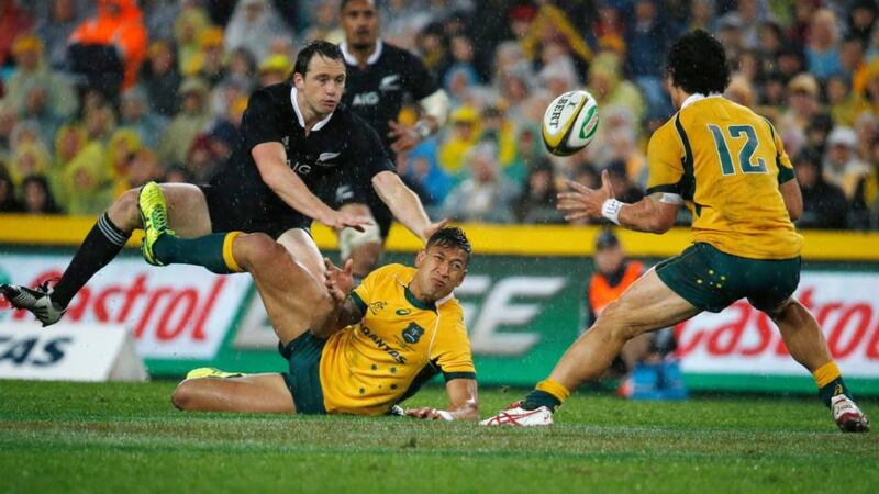 Israel Folau (bottom) of Australia’s Wallabies offloads the ball to teammate Matt Toomua (right) during their Rugby Championship match against New Zealand. Photograph: Jason Reed / Reuters