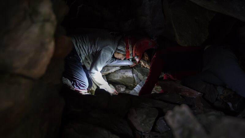 Dr Marion Dowd, IT Sligo and Gearóidín Ní Ghrúinéil of the Mayo Historical and Archaeological Society investigating the human remains in the cave. Photograph: Department of Culture, Heritage and the Gaeltacht
