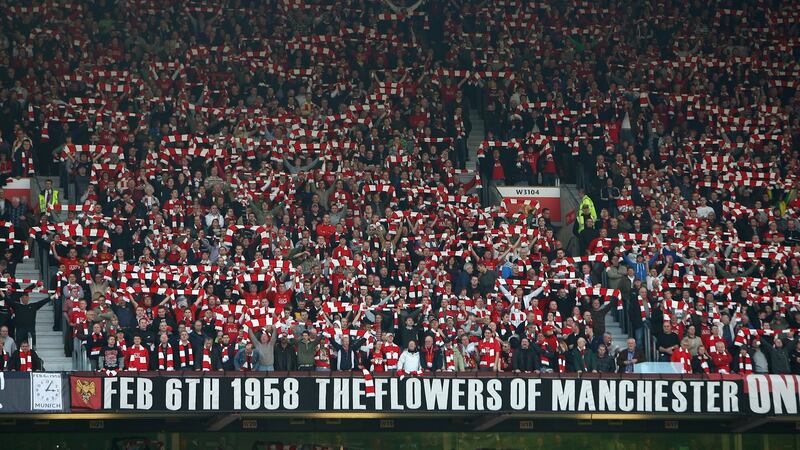 Manchester United fans pay tribute to the Busby Babes on the 50th anniverary of the Munich Air Disaster. Photograph: Alex Livesey/Getty