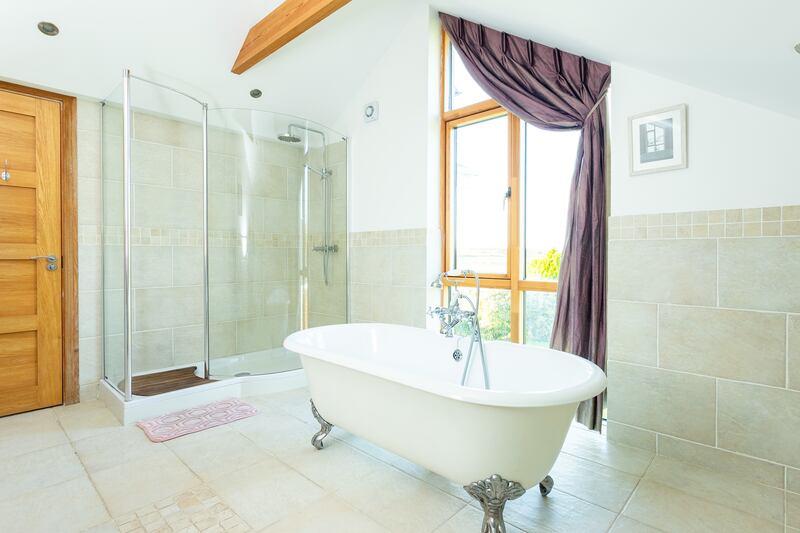 En suite for principal bedroom with freestanding bath