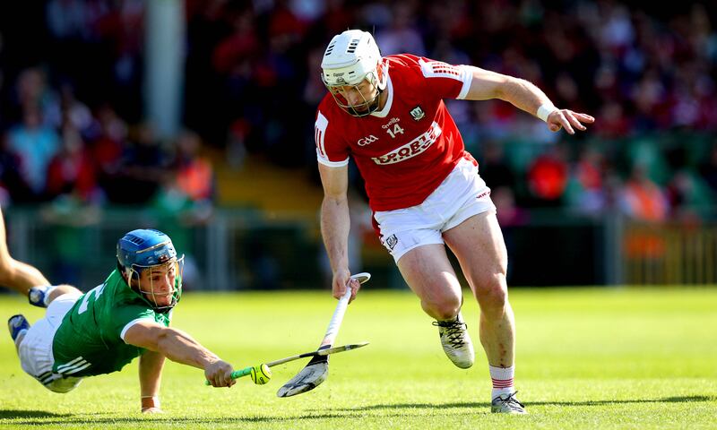 Limerick’s Michael Casey and Patrick Horgan of Cork eludes Limerick's Michael Casey to create the space for his goal. Photograph: Ryan Byrne/Inpho