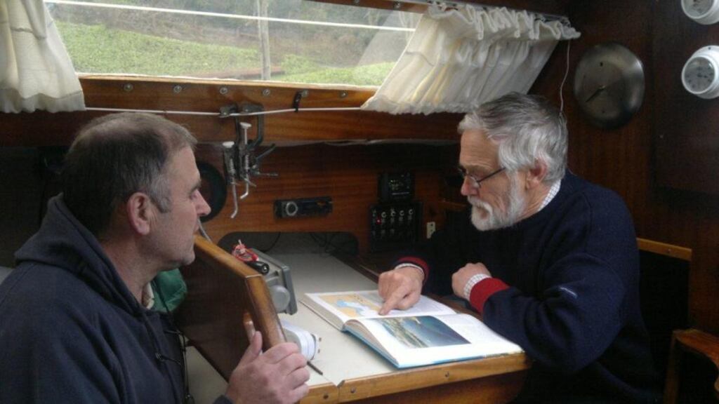 Chris Egan and David Bevan, who have both battled cancer, plotting a course for their round Ireland trip aboard the Inizi in aid of cancer research.