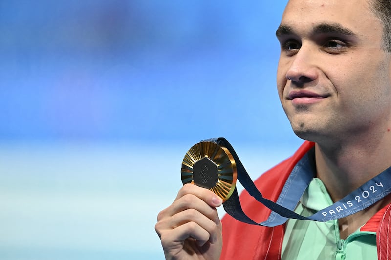 Hungary's Kristof Milak celebrates during the podium ceremony of the men's 100m butterfly. Photograph: Jonathan Nackstrand/AFP/via Getty Images