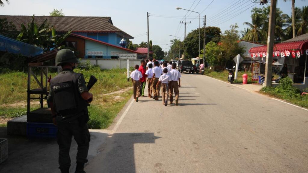 An armed police escort  for Muslim school children in the village of Tak Bai, location of one of the conflict’s worst massacres. Photograph: Tom Farrell