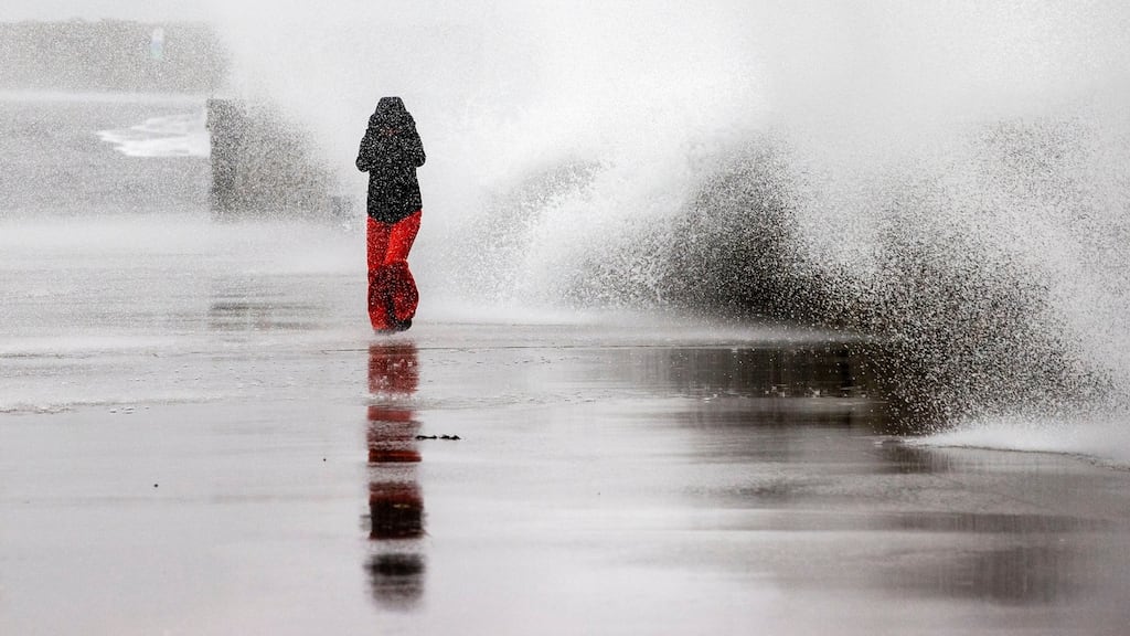 Abigail Doyle walking in the stormy weather on Dún Laoghaire Pier on Sunday. Photograph: Tom Honan