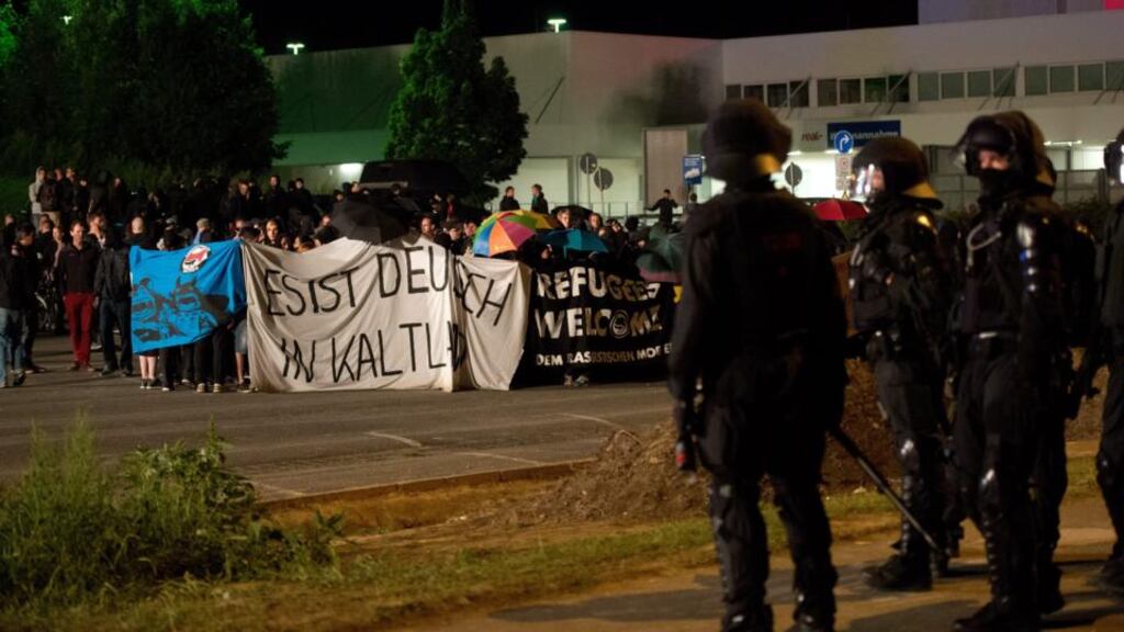 Demonstrators protest opposite the shelter for refugees in the former Praktiker DIY store in Heidenau, Saxony, Germany. Photograph: EPA