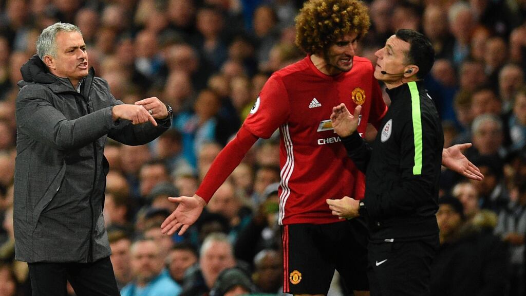 Jose Mourinho and Marouane Fellaini approach fourth official Neil Swarbrick after Fellaini was sent off at the Etihad. Photograph: Getty Images