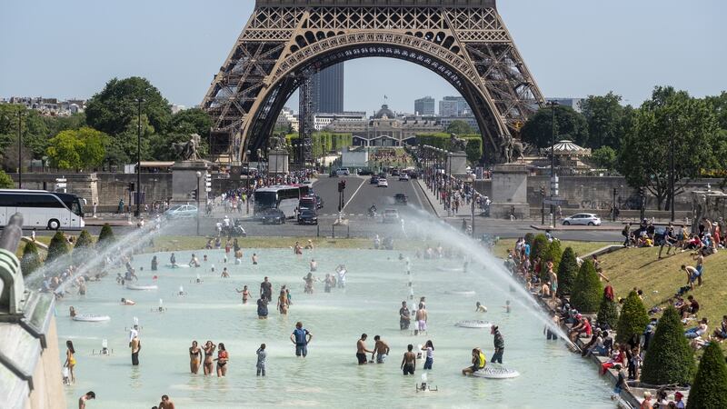 Parisians and tourists cool off in the Trocadero esplanade fountain near the Eiffel Tower in Paris, where the temperature rose to 37 degrees on Saturday. Photograph: Martin Barzilai/Bloomberg.