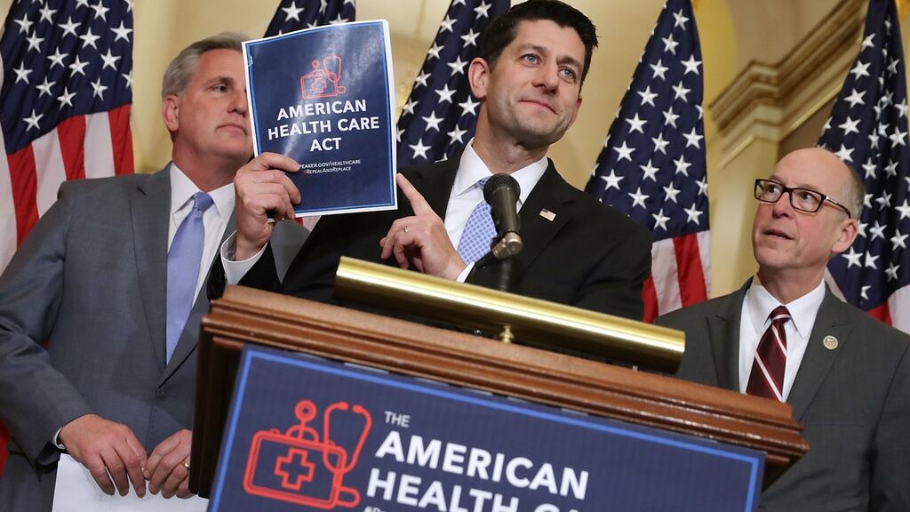 Republican Speaker of the House Paul Ryan  holds up a copy of the American Health Care Act during a news conference unveiling the plan to repeal and replace Obamacare. Photograph: Chip Somodevilla/Getty Images
