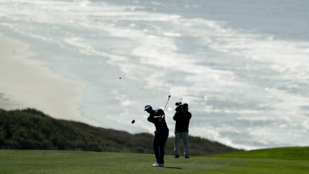Tiger Woods hits from the fairway on the 16th hole hole of the North Course at Torrey Pines Golf Course during the second round of the Farmers Insurance Open in San Diego. Photo: Gregory Bull/AP Photo