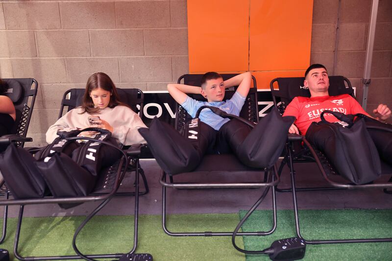 Sarah Goherty and Patrick Goherty, from Dublin, and Lur Ziarrusta 'Intxaurtza, Basque Country, relaxing in compression boots during a break