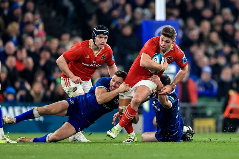 Jack Crowley is tackled by Leinster's Jordan Larmour and Robbie Henshaw. The in-form Munster man now looks a short odds-on bet to start Ireland’s Six Nations opener at houhalf in 10 weeks’ time against France. Photograph: Billy Stickland/Inpho