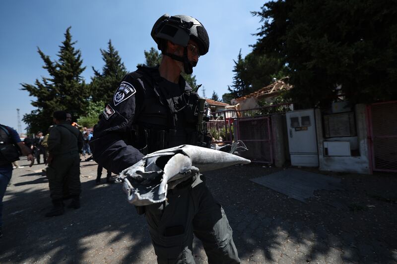 Israeli police carry the remains of a rocket fired from southern Lebanon which hit a house in the city of Safed in the Upper Galilee. Photograph: Atef Safadi/AFP