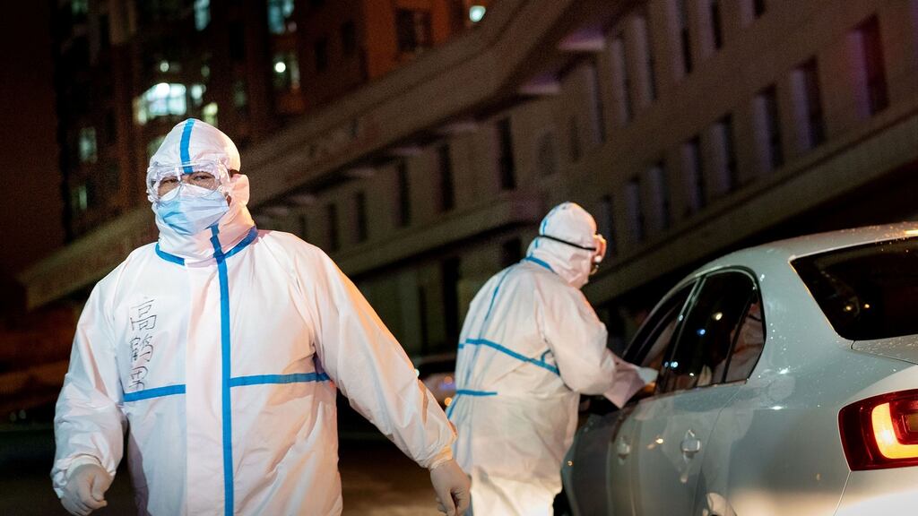 Medical workers in protective clothing in Suifenhe, China’s northeastern Heilongjiang province. Photograph: Getty