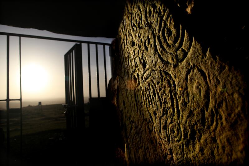 Sunshine illuminates the passageway at the Cairn T Neolithic burial chamber at the start of the Spring Equinox at Loughcrew. Photograph: Alan Betson