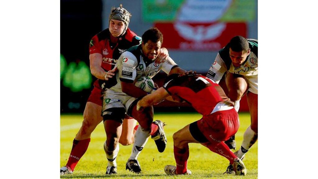 London Irish forward Steffon Armitage is tackled by Scarlets winger Andy Fenby during the Exiles' Heineken Cup Pool Six defeat at Parc y Scarlets yesterday.
