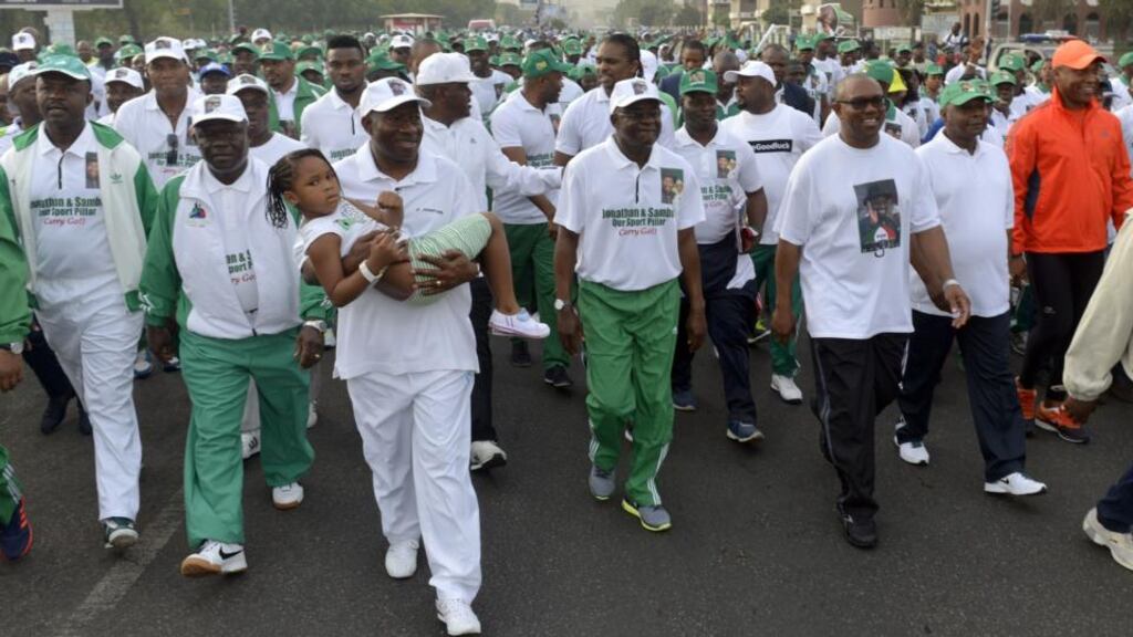 Nigerian president Goodluck Jonathan (C) carries a child as he marches in Abuja on Saturday. Jonathan led government officials as well as leading sports personalities on an outdoor physical training exercise aimed at promoting sports and fitness among state officials and culminating in a rally to drum support for his relection. Presidential elections scheduled for February 14 were delayed for six weeks as the military said the ongoing counter-offensive against Islamist Boko Haram militants meant troops could not provide security on polling day. Elections will take place on March 28th, with gubernatorial and state house assembly polls two weeks later. Photograph: AFP/Getty Images
