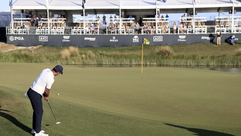 Brooks Koepka putts on the 17th. Photo: Tannen Maury/EPA
