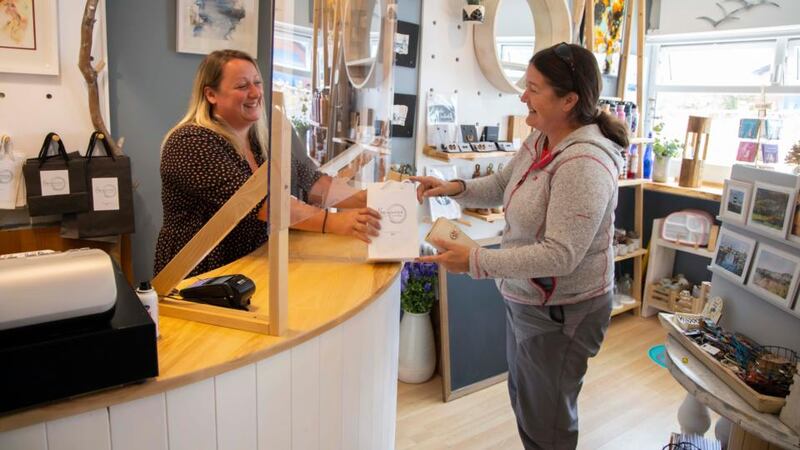 Emma Loftus, owner of Breakwater Gift Shop, with customer Aine Knox: “You can’t run a business with your heart. It has to be with your head.”  Photograph: Patrick Browne