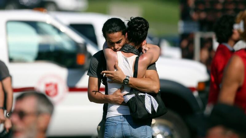 A man console his friend at the Polyvanlente Montignac, the school sheltering the people who were forced to leave their houses after the explosion. Photograph: Mathieu Belanger/Reuters