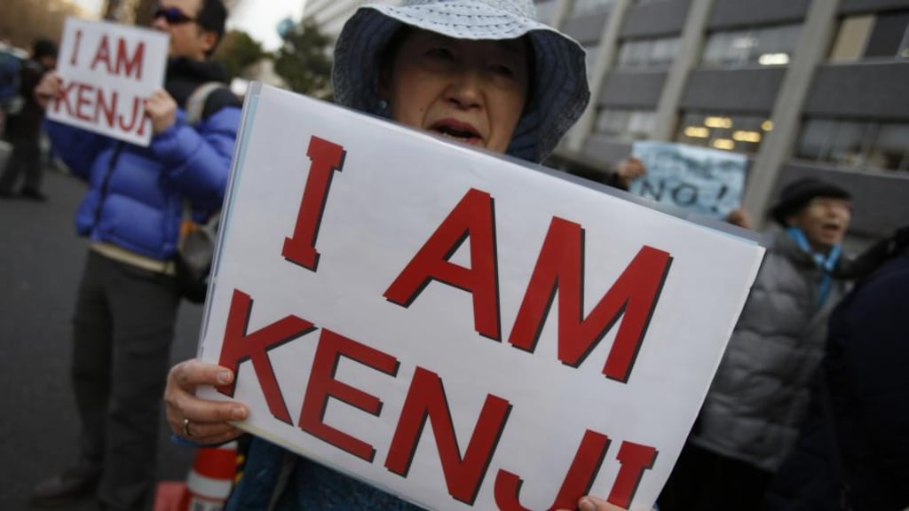 Protesters holding placards during a demonstration in front of the prime minister’s official residence in Tokyo. Some 200 people took part in the demonstration that saw the participants not only protesting against the relocation of a US military base to Henoko in the Okinawa prefecture, but also rallying in support of Kenji Goto, the remaining Japanese captive held by Islamic State militants. Photograph: Yuya Shino/Reuters