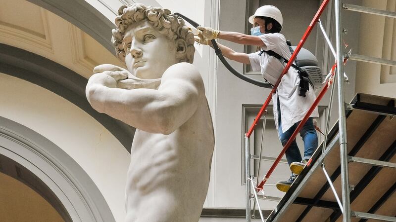 A restorer cleans Michelangelo’s David statue while preparing for the reopening of the Galleria dell’Accademia which was closed for almost three months due to coronavirus. Photograph: Laura Lezza/Getty Images