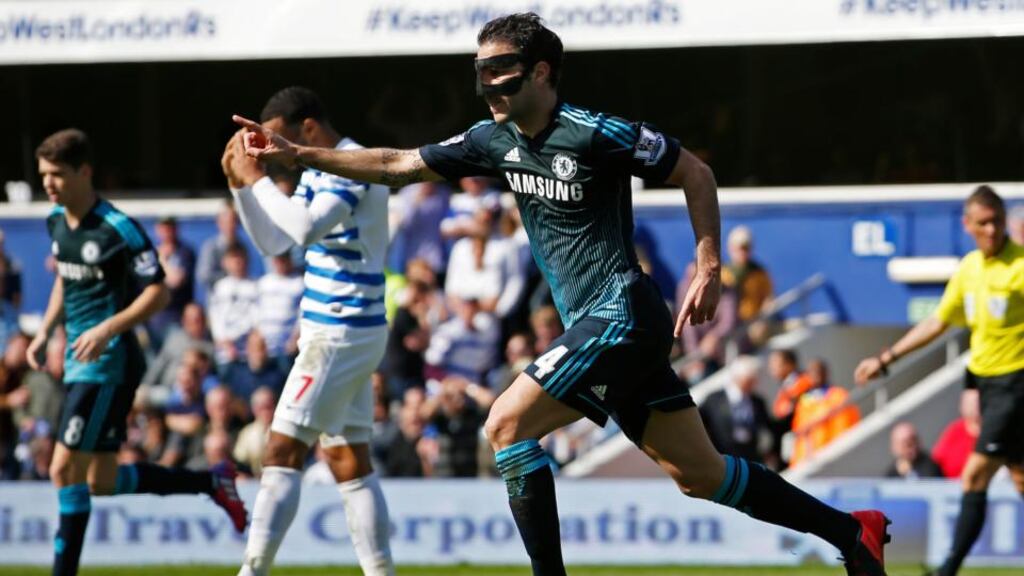 Cesc Fabregas, wearing a protective mask, scored a late winner for Chelsea at Loftus Road. Photograph: Inpho