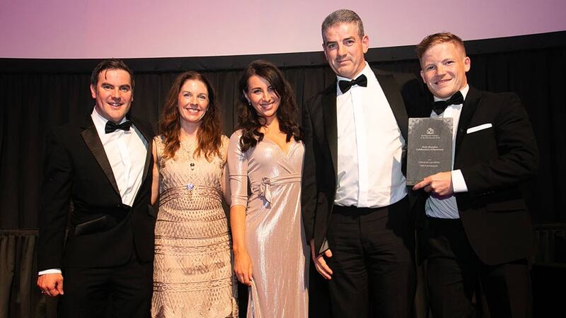 Brett O'Sullivan, Business Development Manager, Kingspan Insulation presents the Multi-Discipline Collaboration Achievement award to the MOLA Architecture Team.