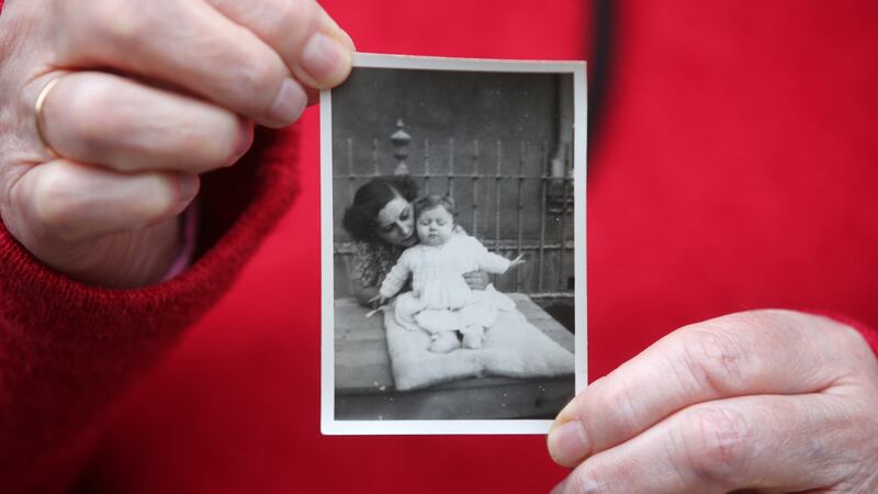 Joyce McSharry holding a photograph of her with her birth mother. Photograph : Laura Hutton