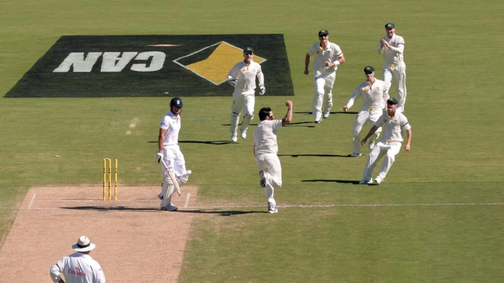Australia’s Mitchell Johnson celebrates bowling out England’s Alastair Cook during day two of the second Test at the Adelaide Oval. Photograph: Anthony Devlin/PA