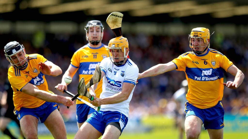 Waterford’s Peter Hogan is challenged by Cathal Malone and Colm Galvin of Clare during the Munster SHC round-robin game at Walsh Park. Photograph: Ryan Byrne/Inpho