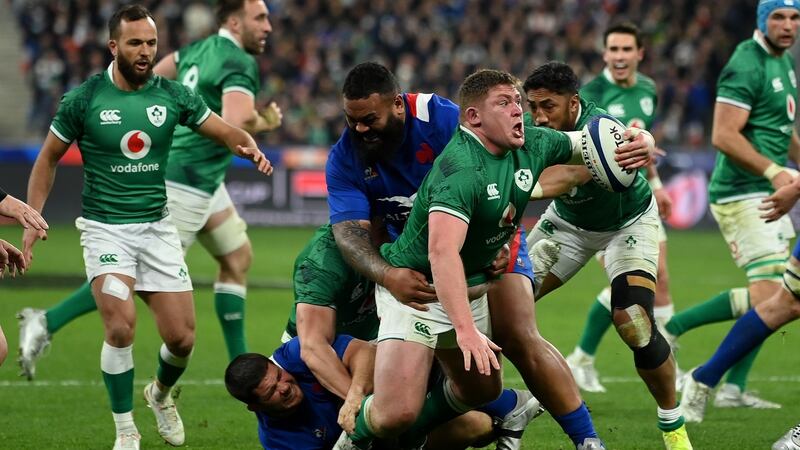 Tadhg Furlong of Ireland is tackled by Uini Atonio. Photograph: Mike Hewitt/Getty