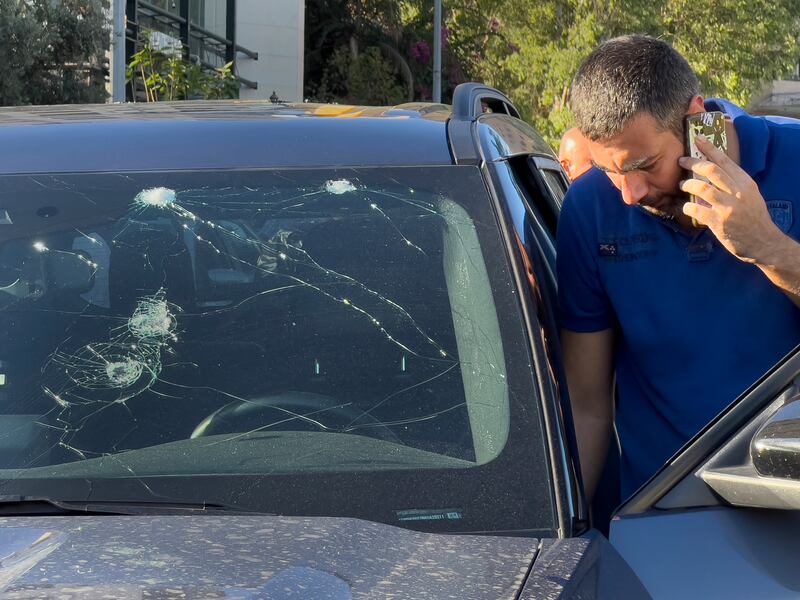 A police officer inspects a car in which a hand-held pager exploded. Photograph: Hussein Malla/AP