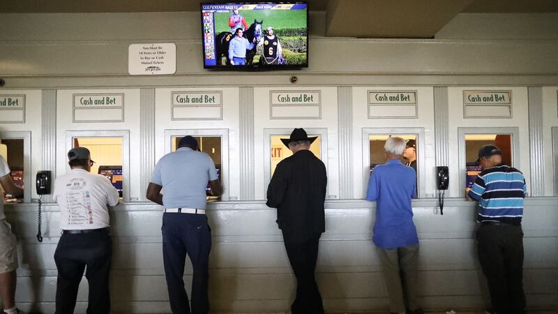 Punters at betting windows on the final day of the winter/spring horse racing season at Santa Anita Park on June 23. Photograph: Mario Tama/Getty Images