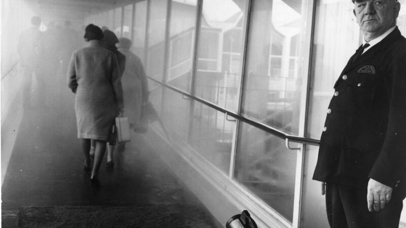 Passengers at Dublin Airport passing through a mist of disinfectant spray in 1967. Photograph: Gordon Standing